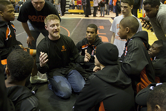 MINNEAPOLIS -- Members of the Minneapolis South High School varsity wrestling team gather around assistant coach Joe Morgan (kneeling) following a 52-28  dual meet loss to Waconia High School on January 12, 2012 at South.