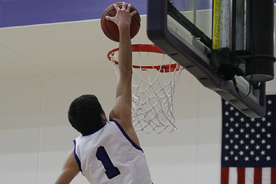 St. Bonafacious, Minn. -- Truman Shelter goes up for a dunk during a game between Crown College (Minn.) and Presentation (S.D.) on January 13, 2012 at Crown College in St. Bonafacious. Shelter electrified the crowd with the game's only dunk as Crown hung on to win 91-79.