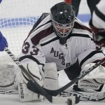 MINNEAPOLIS -- Augsburg goaltender Alex Hall reaches for the puck during a scramble in front of the net during the third period of a 1-1 draw with the College of St. Scholastica. Hall made 44 saves during the game, her third of the season.
