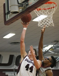 120123-AUGS-HMLN-M-130-blog MINNEAPOLIS -- Augsburg basketball player Andy Grezesiak-Grimm scores his 1000th point at college player over Hamline's Dior Ford in a Div. III men's basketball game between the Auggies and the Pipers in Minneapolis on Jan. 23, 2012.