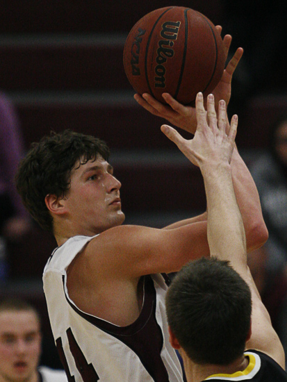 MINNEAPOLIS -- Augsburg basketball player Andy Grzesiak-Grimm takes a shot in the second half of a 73-63 loss to conference co-leader Gustavus Adolphus.  Grzesiak-Grimm scored 20 points and pulled down 11.