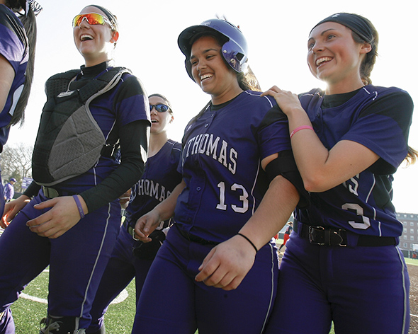 ST. PAUL, MINN. (April 6, 2014) -- St. Thomas' Brenna Walek celebrates with teammates after hitting her third romerun of the game as part of a 6-0 win by the Tommies.
