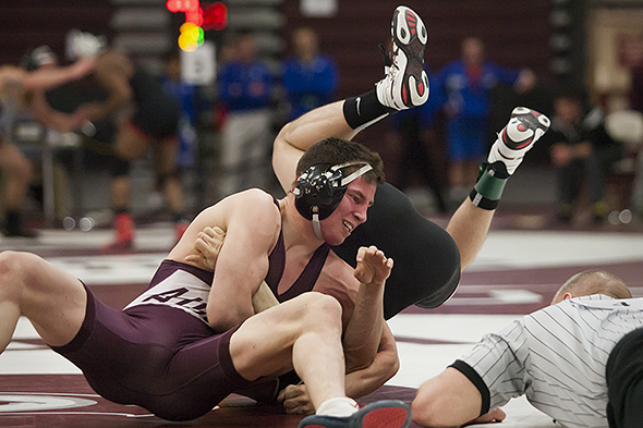 Augsburg's Chad Bartschenfeld (left) grapples with St. John's Evan Guffey in their 133 pound third-place match at the 2015 NCAA Div. III Wrestling West Regional at Augsburg College's Si Melby Hall on Feb. 28, 2015. Bartschenfeld won the match 6-0 to qualify for the National Championships on March 14-15.