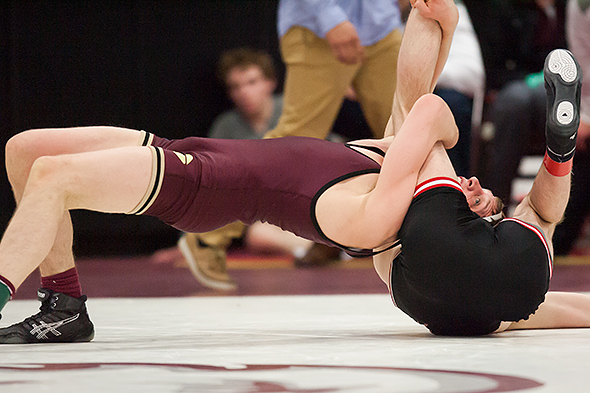 Concordia's Jacoby Bergeron (left) rolls through a scramble situation in his 141 pound first-place match at the 2015 NCAA Div. III Wrestling West Regional with Ben Henle (St. John's) on Feb. 28, 2015 at Augsburg College's Si Melby Hall. Bergeron prevailed 6-5.