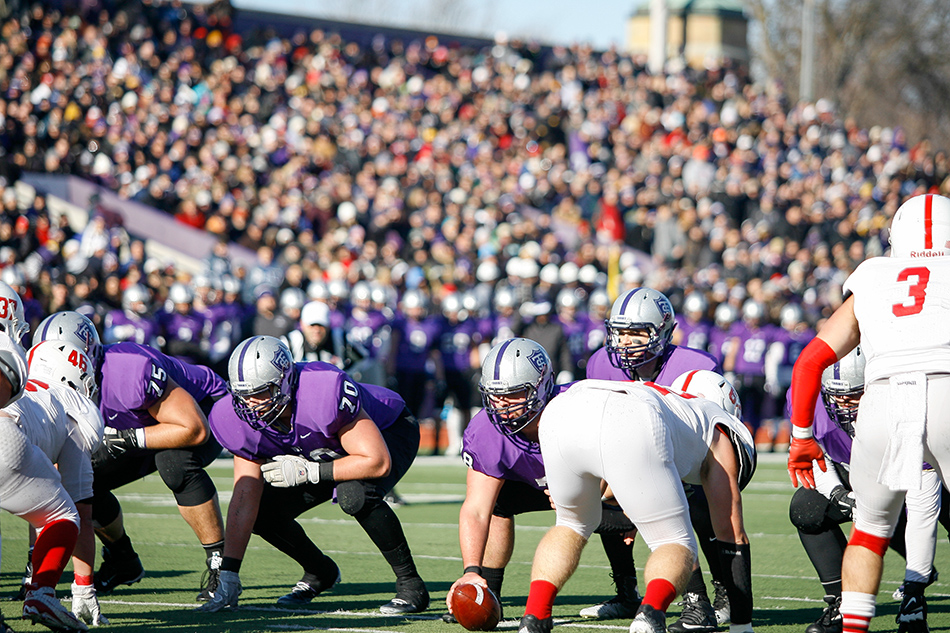 ST. PAUL, MINN. (Nov. 28, 2015) -- The St. Thomas offensive line prepares for a play in front of a crowd of 8,025 fans at St. Thomas' O'Shaughnessy Stadium during the first quarter of an NCAA Div. III Football second round playoff game in St. Paul, Minn. The No. 4 Tommies defeated their arch-rival No. 10 Johnnies 38-19. On this drive, the Tommies failed to convert a turnover in Johnnie territory into any points after a failed field goal attempt.