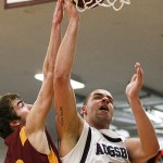 Augsburg center Cory Polta puts up a shot over Concordia-Moorhead's Aaron Lindahl during a game between the Auggies and the Cobbers on December 3, 2011 in Minneapolis. Polta had a career high 27 points in the contest, earning M.I.A.C Men's Basketball Player of the Week for his efforts. (Caleb Williams/d3photography.com)