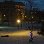 A man lays down in the snow to take a picture of his custom bicycle in Loring Park near downtown Minneapolis, Minn. on the evening of Jan. 1, 2012.