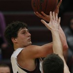 MINNEAPOLIS -- Augsburg basketball player Andy Grzesiak-Grimm takes a shot in the second half of a 73-63 loss to conference co-leader Gustavus Adolphus. Grzesiak-Grimm scored 20 points and pulled down 11.