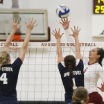 Augsburg volleyball player Colleen Ourada (6) tips the ball over UW-Stout's Morgan Denny (4) and Karley Wiensch (1) in the first set of a match between UW-Stout on September 11, 2014. Augsburg won 3-2 (25-12, 15-25, 25-18, 18-25, 15-9). Ourada had 14 kills.